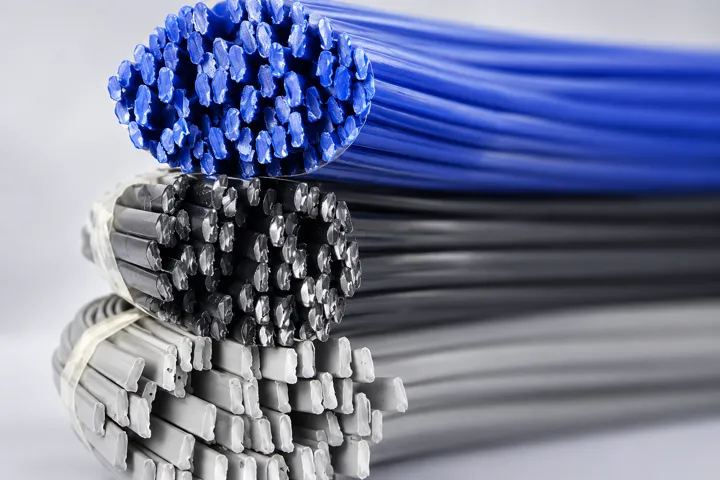 Stacked blue, black and grey plastic welding rods